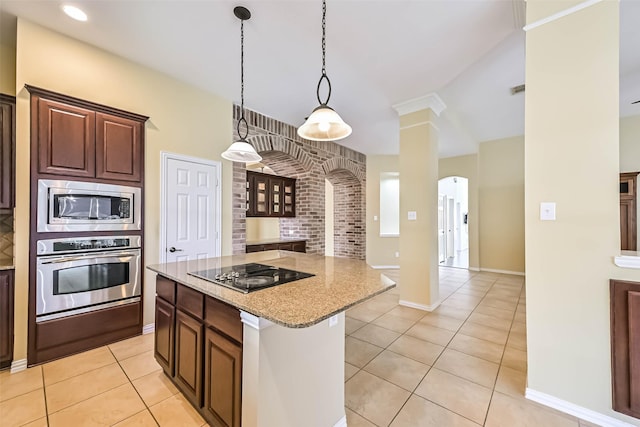 kitchen with light tile patterned floors, decorative columns, appliances with stainless steel finishes, light stone countertops, and a warming drawer