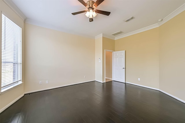 unfurnished room featuring baseboards, visible vents, dark wood finished floors, and crown molding