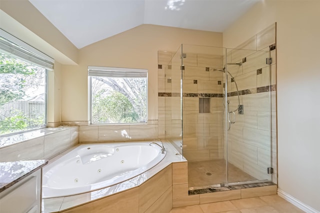 bathroom with lofted ceiling, vanity, a shower stall, tile patterned floors, and a whirlpool tub