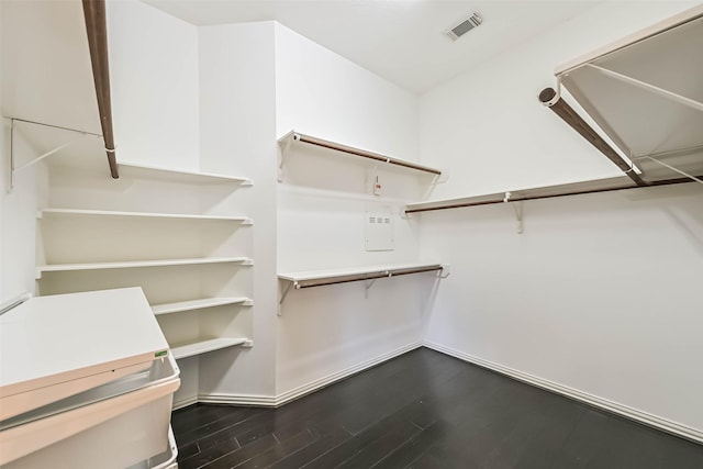 spacious closet featuring dark wood-style floors and visible vents