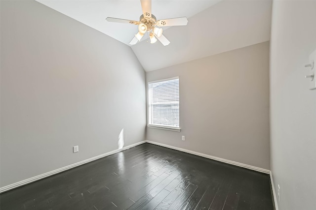 unfurnished room with dark wood-style floors, ceiling fan, baseboards, and vaulted ceiling