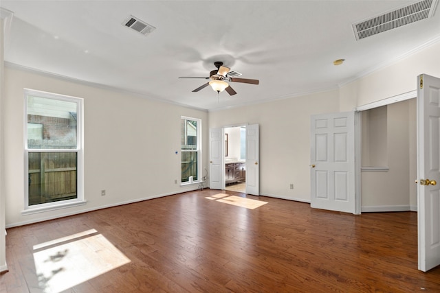 spare room featuring visible vents, ceiling fan, baseboards, and wood finished floors