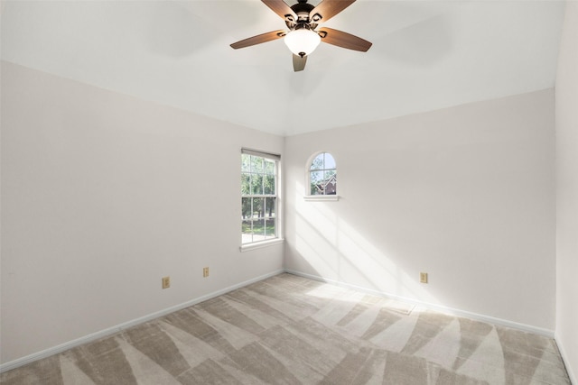 empty room with baseboards, vaulted ceiling, and carpet flooring