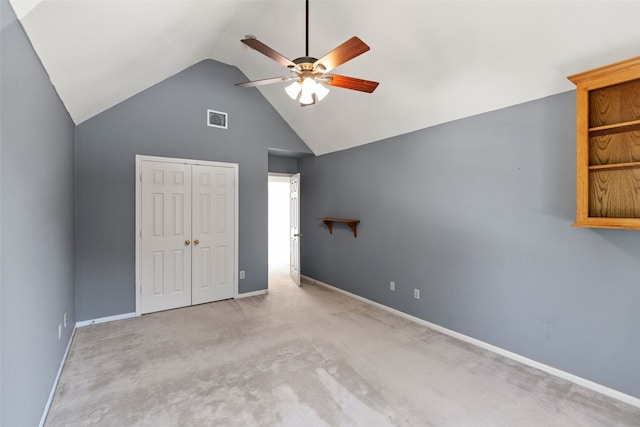 unfurnished bedroom with lofted ceiling, a closet, visible vents, carpet flooring, and baseboards