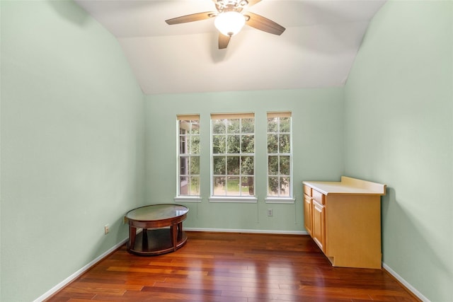 unfurnished room featuring lofted ceiling, wood-type flooring, baseboards, and a ceiling fan