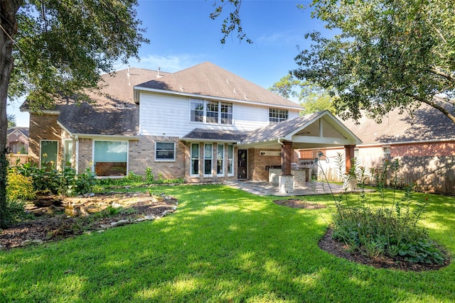 rear view of house featuring a patio area, fence, a lawn, and brick siding