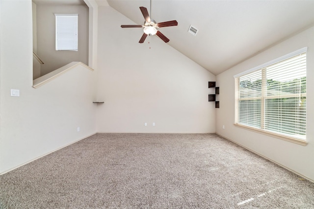 unfurnished room with ceiling fan, carpet floors, high vaulted ceiling, and visible vents