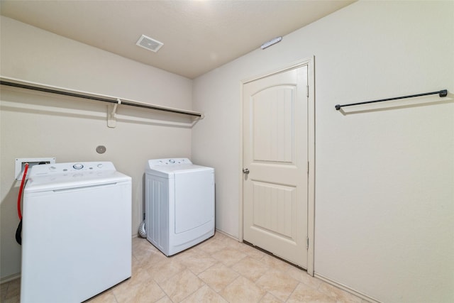 clothes washing area featuring laundry area, washing machine and dryer, and visible vents