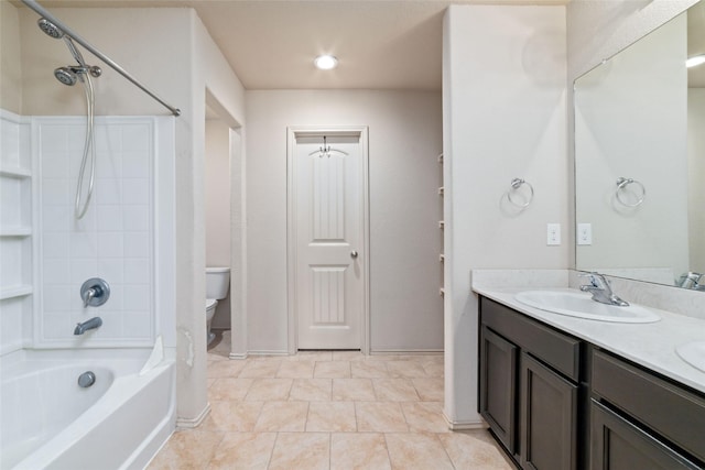 bathroom featuring a sink, shower / bathing tub combination, toilet, and double vanity