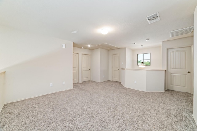 spare room with visible vents and light colored carpet