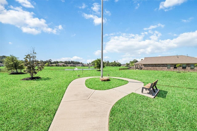 view of property's community featuring a yard