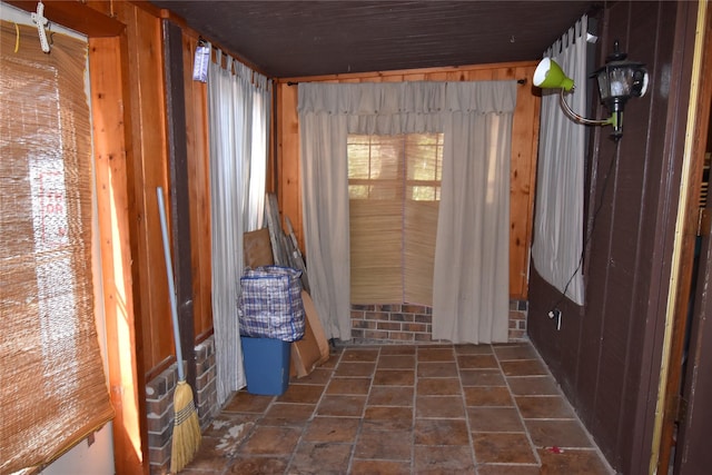 interior space with stone finish floor and wooden walls