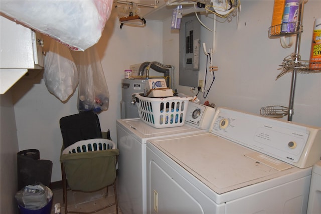 washroom featuring laundry area, electric panel, washing machine and clothes dryer, and water heater