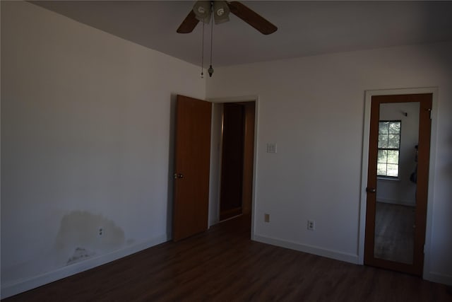 spare room featuring ceiling fan, baseboards, and wood finished floors