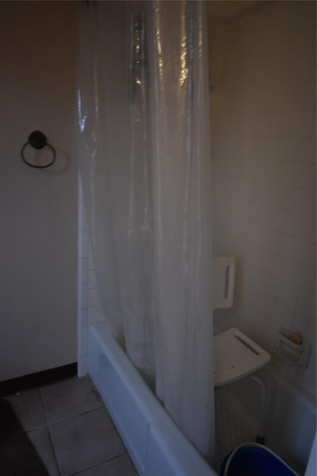 full bath featuring shower / bath combination with curtain and tile patterned flooring