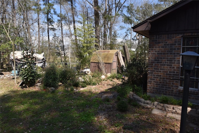 view of yard with an outbuilding and a shed