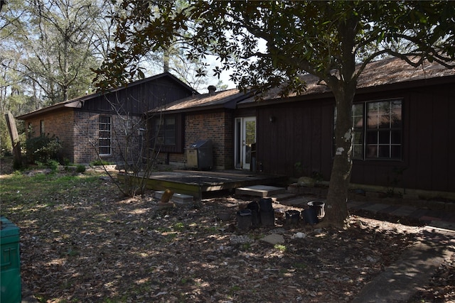 view of front of property with a deck and brick siding