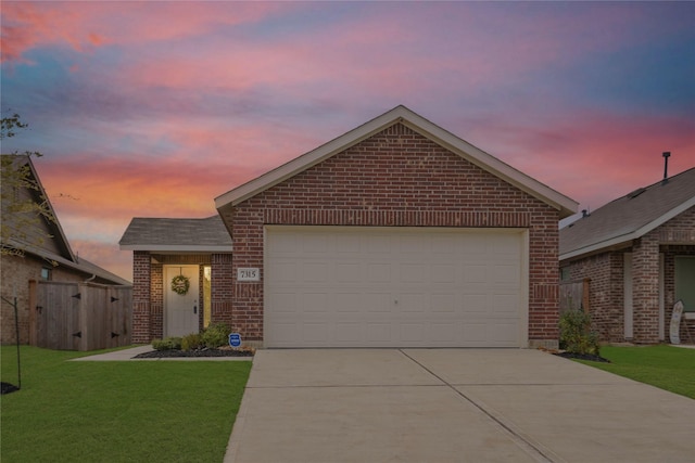 view of front of home featuring driveway, brick siding, an attached garage, fence, and a front yard