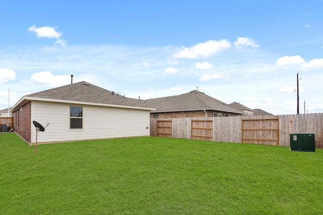 back of house with a fenced backyard, central AC, and a lawn