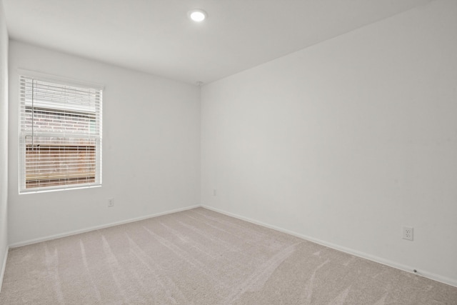 empty room featuring carpet floors, recessed lighting, and baseboards