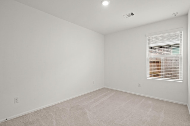 unfurnished room featuring baseboards, recessed lighting, visible vents, and light colored carpet