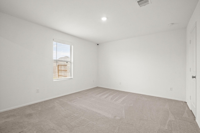 unfurnished room with carpet floors, baseboards, visible vents, and recessed lighting