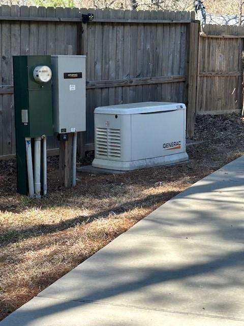 details featuring fence and a power unit