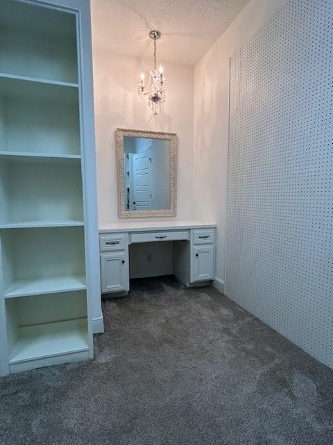 bathroom with a notable chandelier, a textured ceiling, and vanity