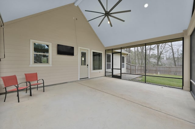 unfurnished sunroom featuring lofted ceiling and a ceiling fan