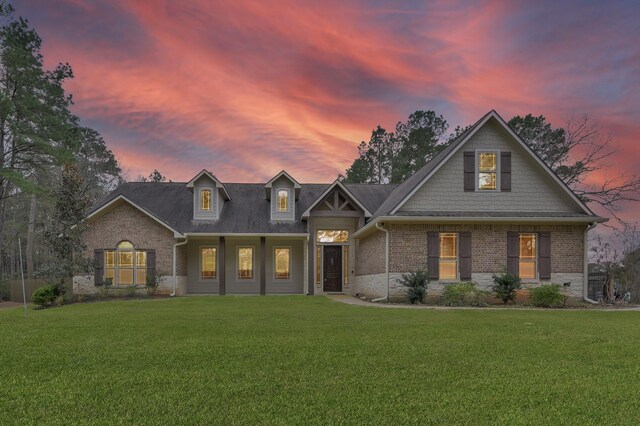 craftsman inspired home with brick siding and a front lawn