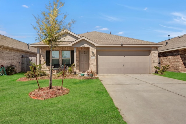 view of front of house with a shingled roof, concrete driveway, an attached garage, a front lawn, and brick siding