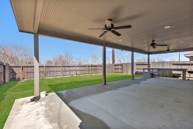 view of patio with a fenced backyard and ceiling fan