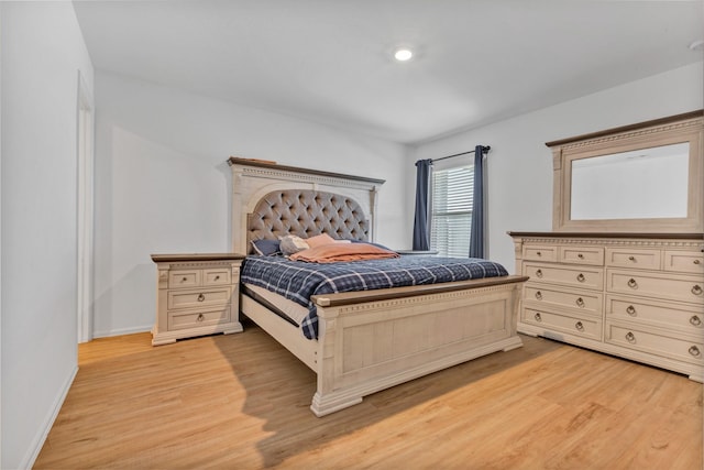 bedroom with baseboards and light wood-style floors