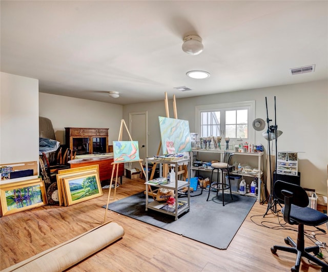 interior space with wood finished floors and visible vents