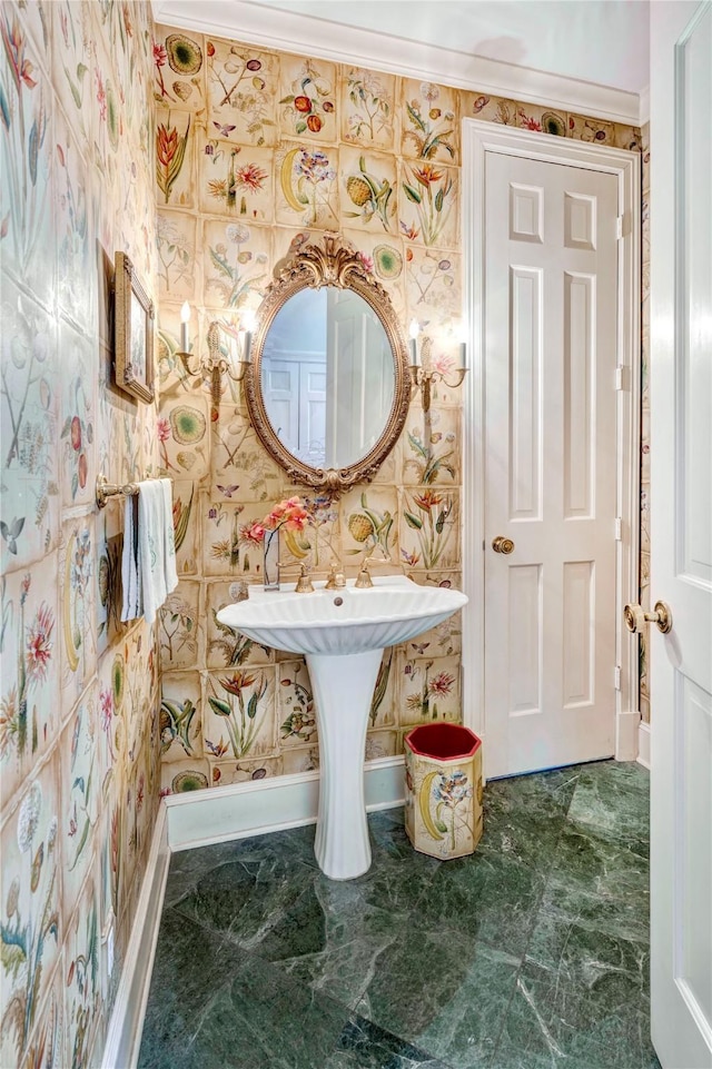 bathroom with baseboards and wallpapered walls