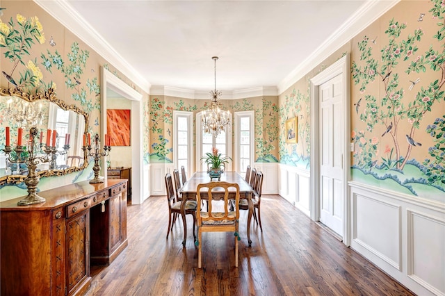 dining space featuring wood finished floors, wainscoting, a notable chandelier, and wallpapered walls