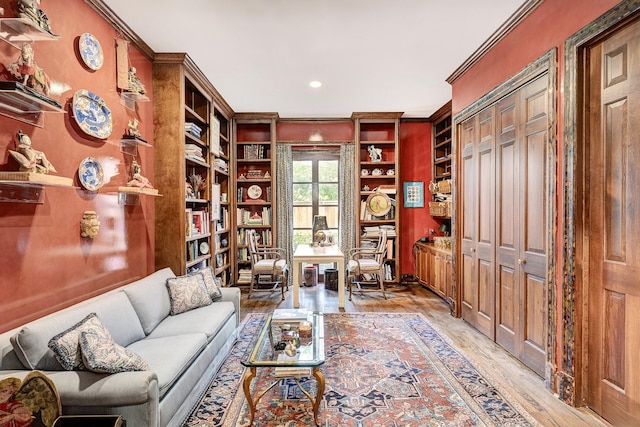 living area with light wood finished floors and crown molding