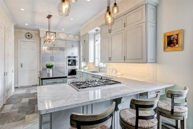 kitchen featuring ornamental molding, a peninsula, a sink, stainless steel appliances, and backsplash