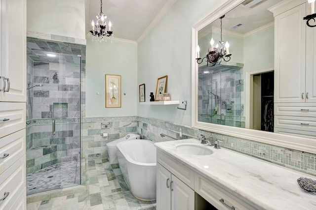 full bathroom featuring visible vents, ornamental molding, a freestanding tub, a shower stall, and a notable chandelier