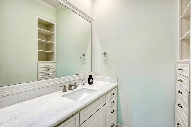 bathroom featuring crown molding and vanity