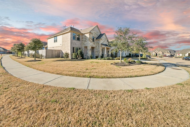 view of front facade featuring a front yard and stone siding