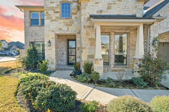 doorway to property featuring stone siding