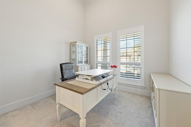 office area with light carpet and baseboards