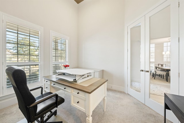 office space with baseboards, light colored carpet, and french doors