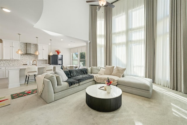 living area featuring a ceiling fan and recessed lighting