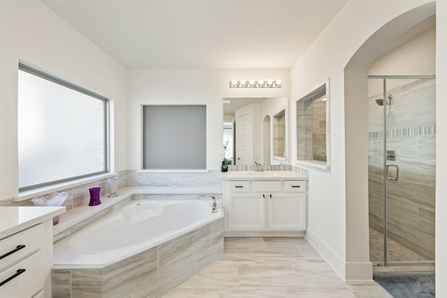 full bathroom with marble finish floor, vanity, a shower stall, and a bath