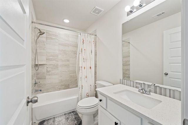 bathroom with visible vents, shower / tub combo with curtain, vanity, and toilet