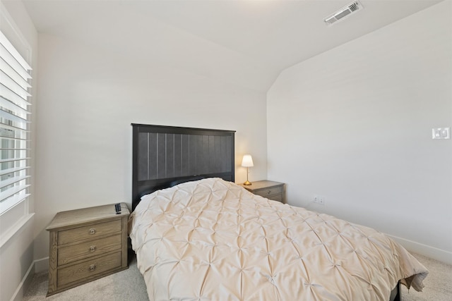 bedroom featuring lofted ceiling, carpet flooring, visible vents, and baseboards