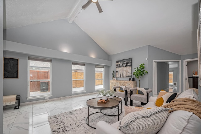 living area with ceiling fan, high vaulted ceiling, baseboards, marble finish floor, and beam ceiling