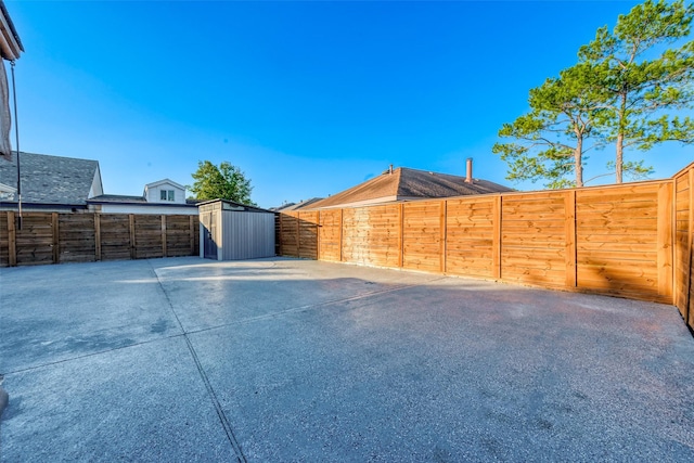 exterior space with a storage shed, a patio, an outdoor structure, and a fenced backyard